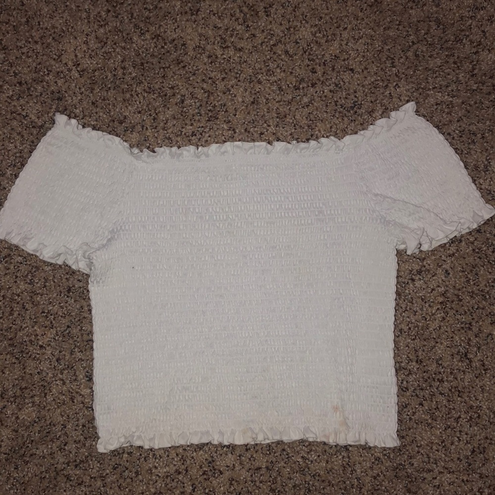 A white off the shoulder crop top by Stella Tweed